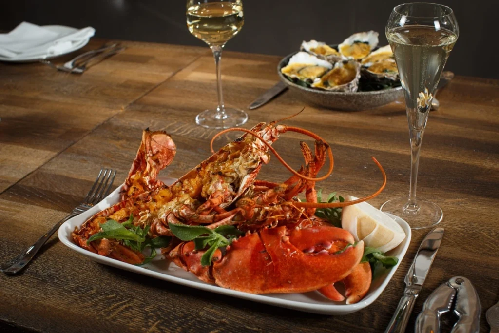 Lobster on a plate served with white wine in Sole, one of the seafood places in Dublin, Ireland